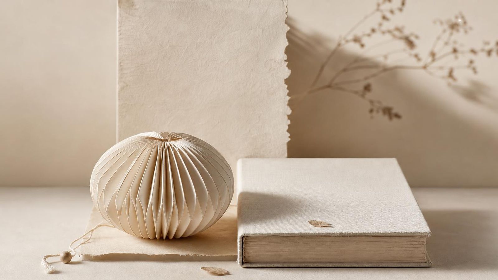 A plain lamp casting warm light on a paper-toned desk at night